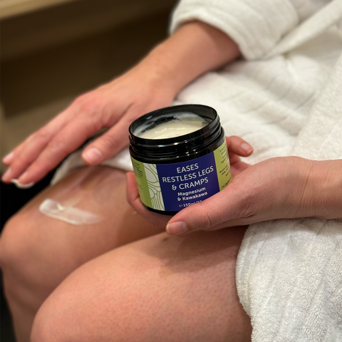 Cream jar held against the leg, wrapped in a blanket