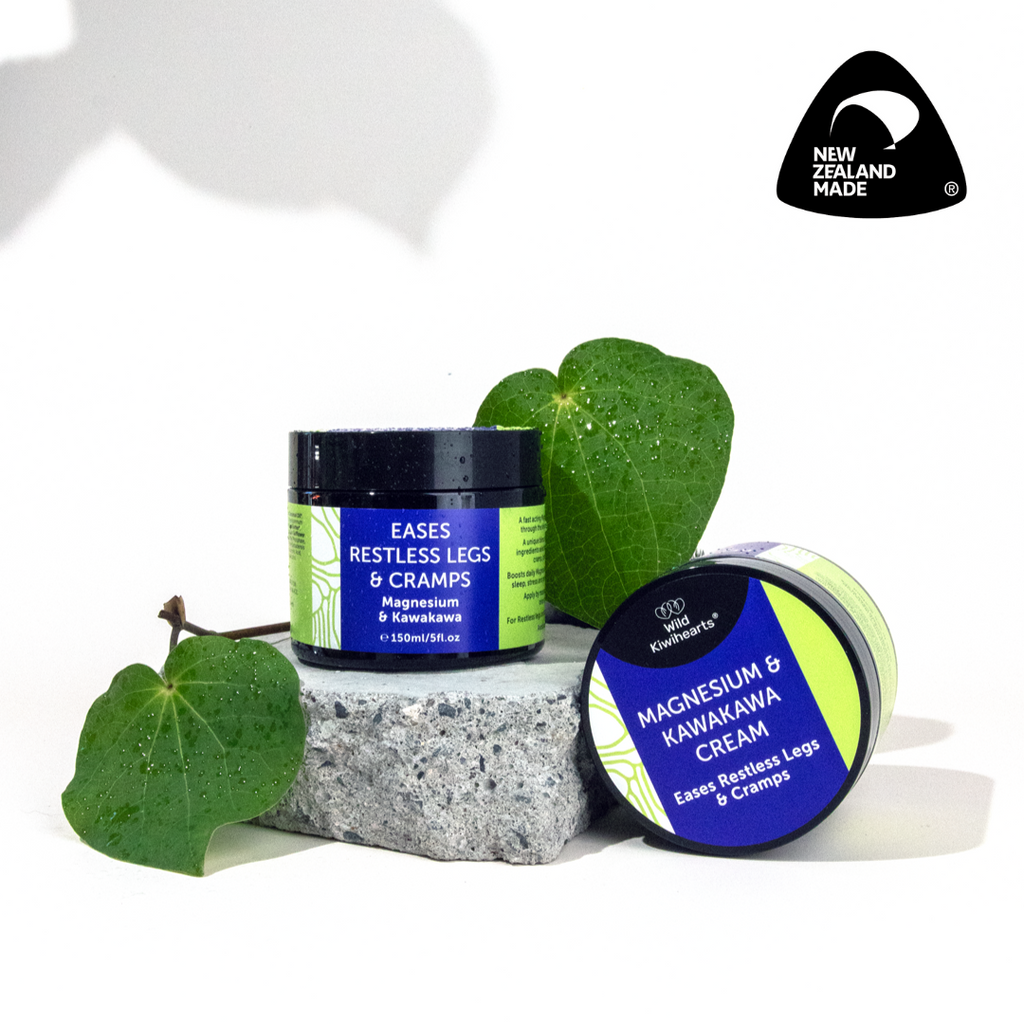 Magnesium and Kawakawa cream tubs with green leaves on a white background